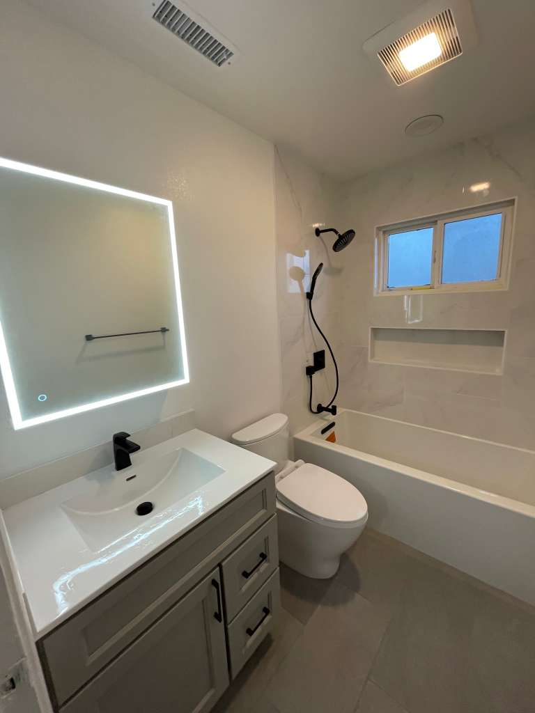 LED mirror bathroom remodel with modern finishes