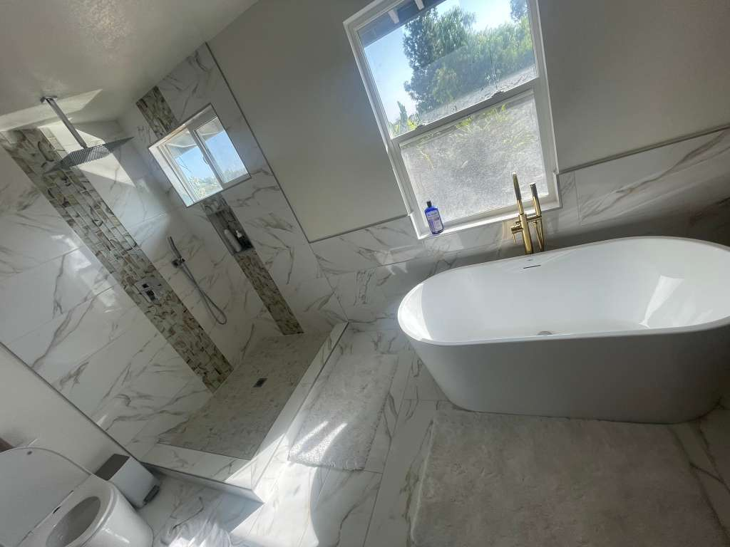 Freestanding tub with gold fixtures bathroom remodel