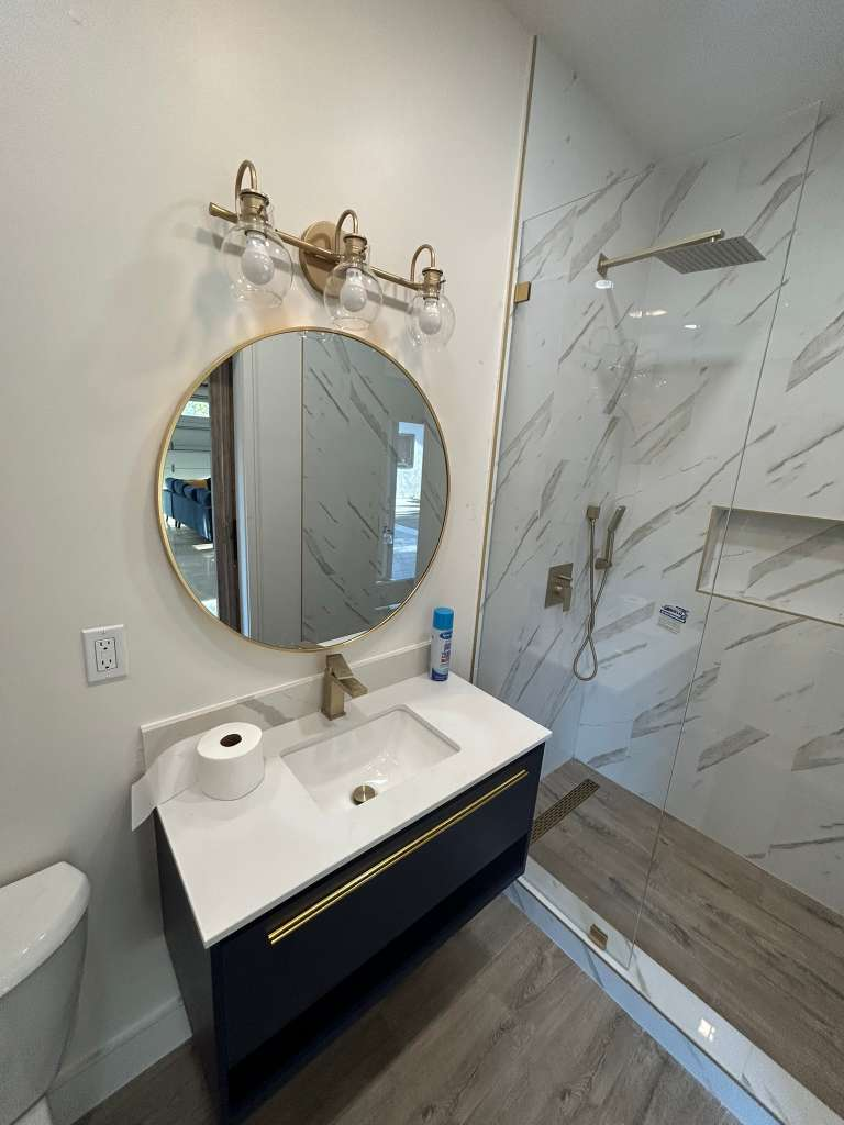 Navy vanity with gold fixtures luxury bathroom remodel