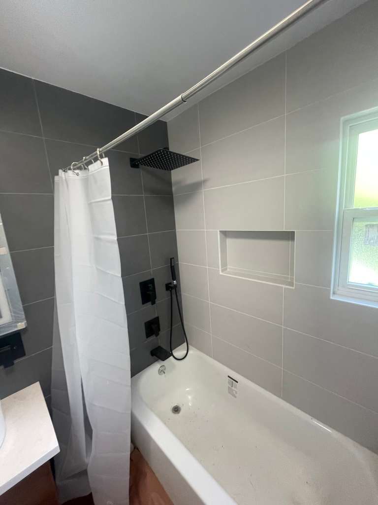 Modern gray tile tub and shower remodel