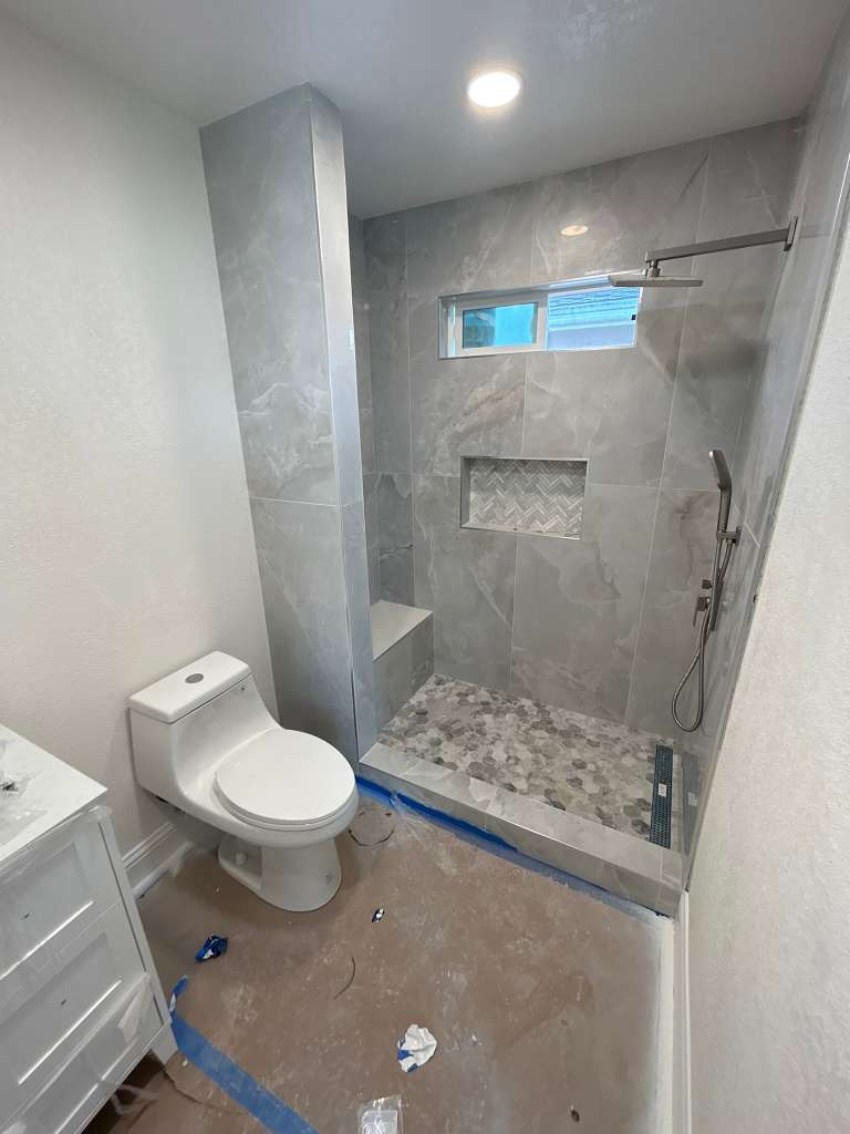 Walk-in shower with pebble floor bathroom remodel